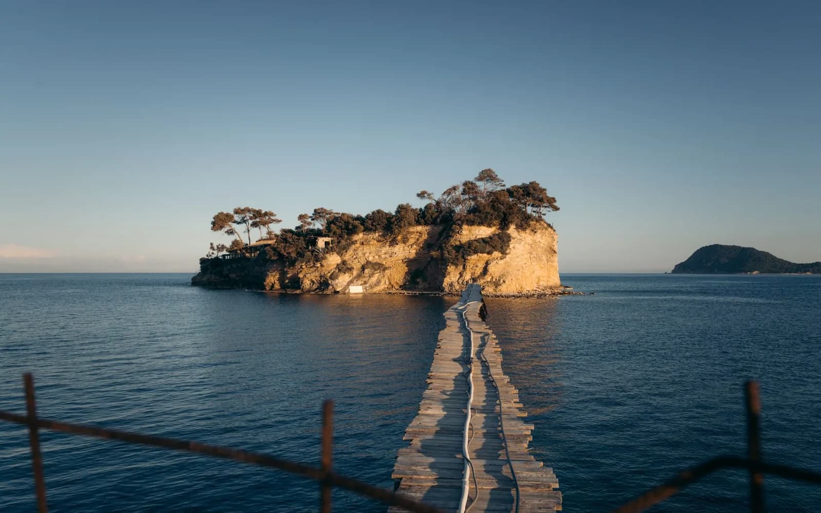 The wooden footbridge running out to Cameo island at Agios Sostis in Laganas bay, Zakynthos, at sunset
