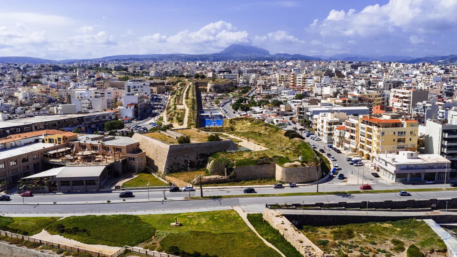 Heraklion from the air, the Venetian walls and their dry moat cutting through the modern city, Crete