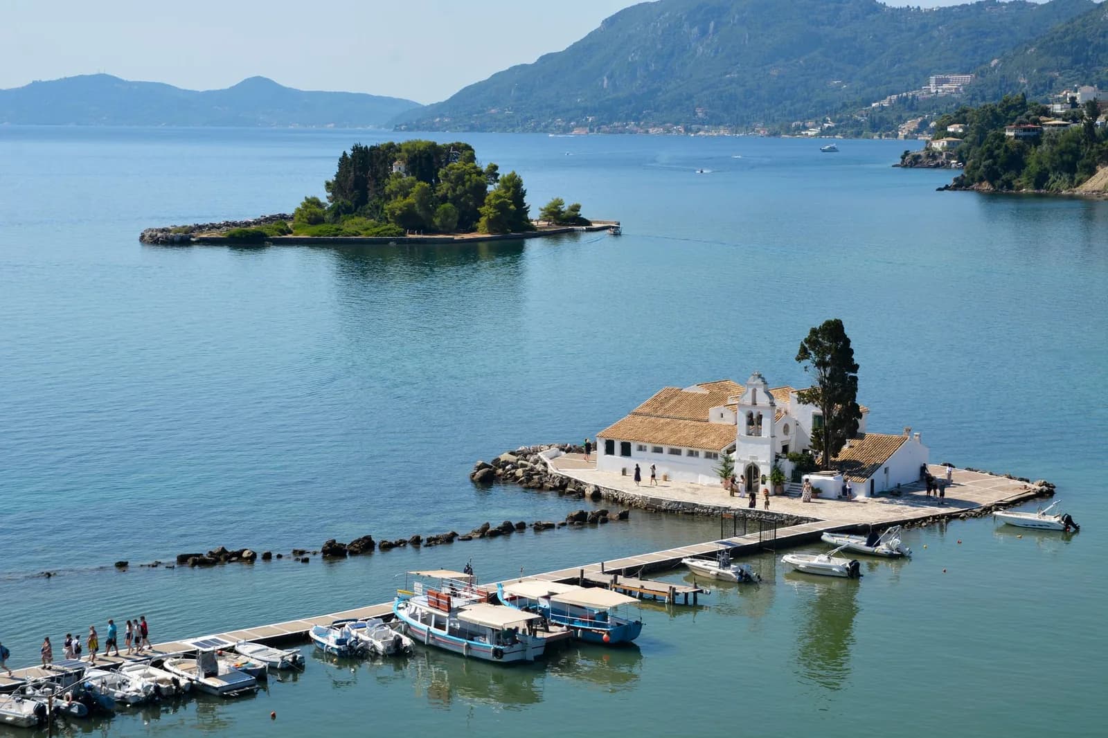 Vlacherna monastery on its jetty and the wooded islet of Pontikonisi seen from Kanoni, Corfu, at the southern end of the airport runway
