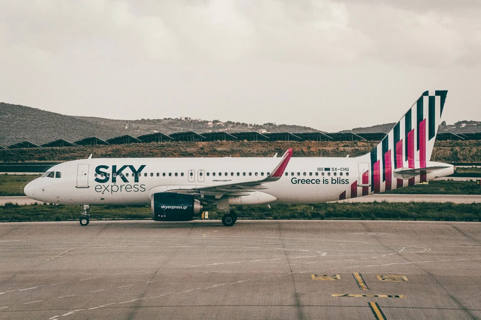 A Sky Express Airbus A320neo on the taxiway, one of the two carriers flying the Greek domestic island network from Athens