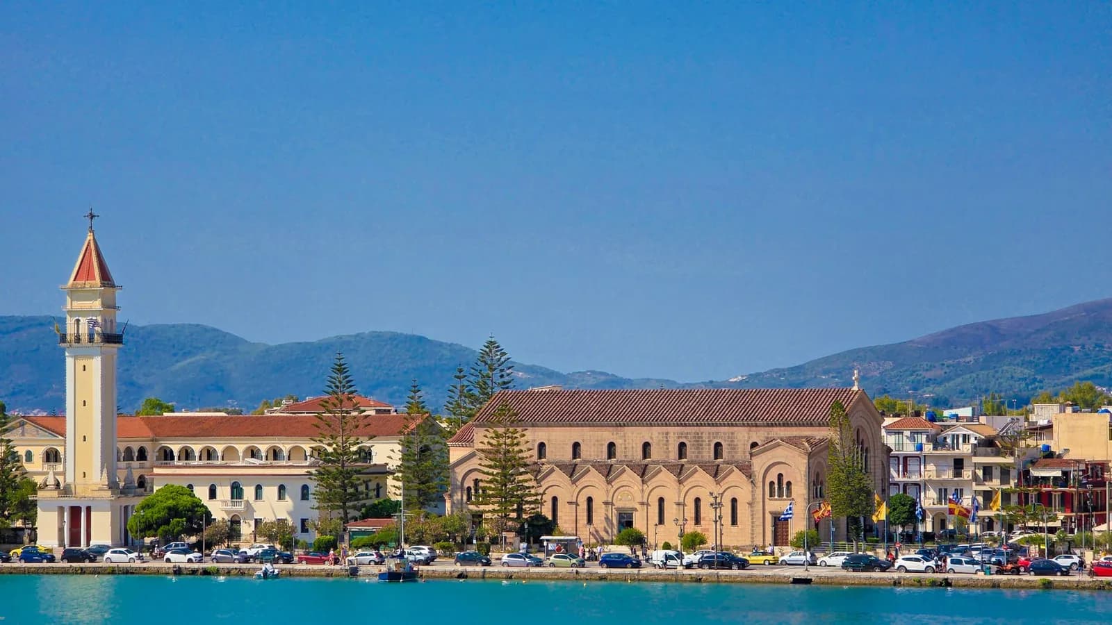 The waterfront of Zakynthos Town seen from the harbour, with the bell tower and basilica of Agios Dionysios above the quay