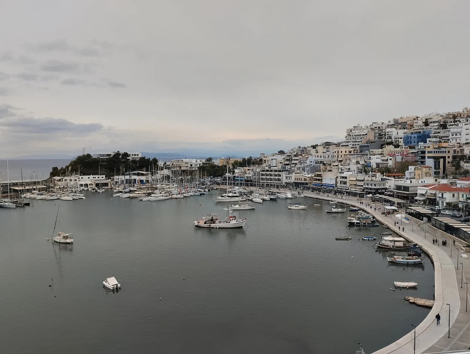 Mikrolimano harbour in Piraeus, with boats moored along the waterfront promenade