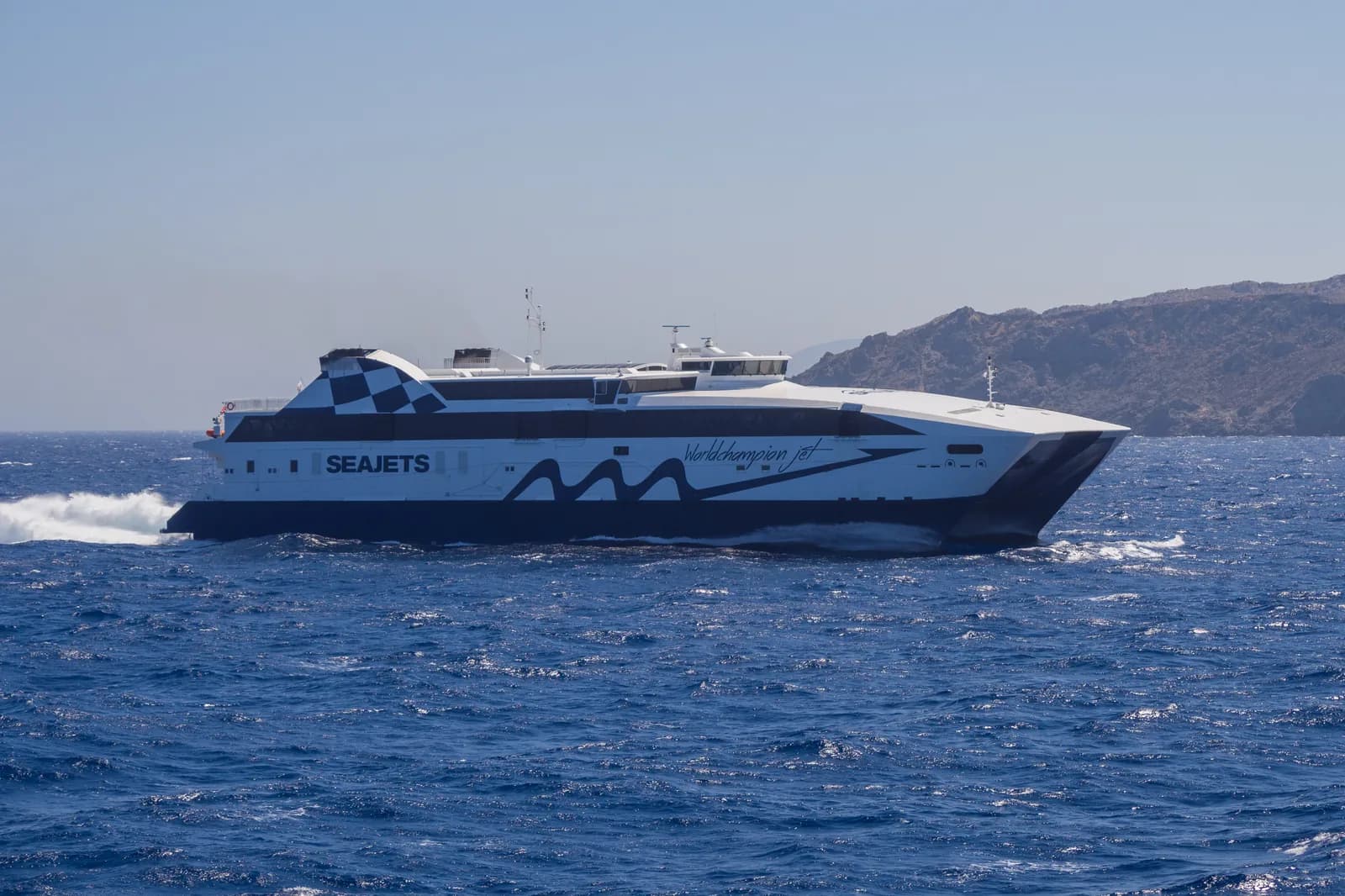 The SeaJets high-speed catamaran WorldChampion Jet speeding through the blue Aegean off Ios in the Cyclades
