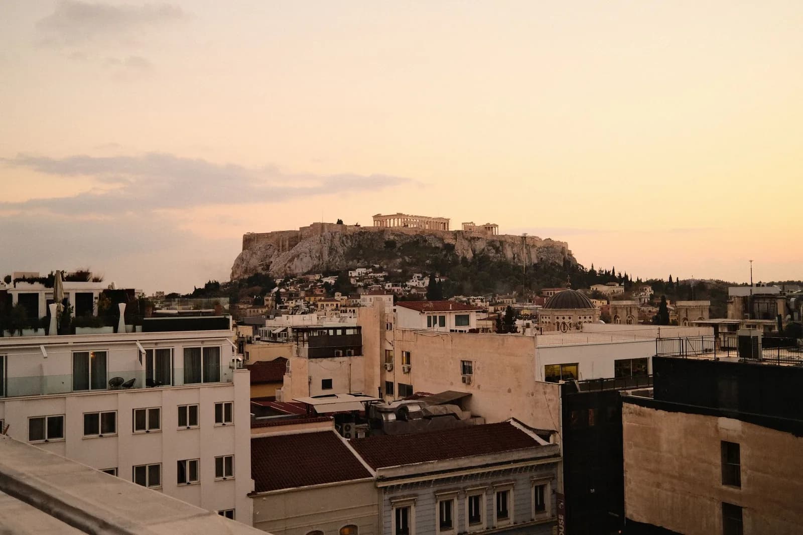 The Acropolis and the Parthenon rising above the rooftops of central Athens at sunset