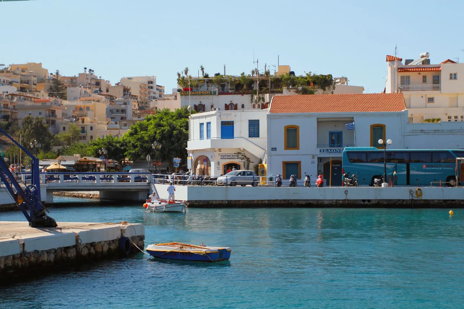 The harbour at Agios Nikolaos in eastern Crete, with fishing boats, the bridge over the lake channel and the town rising behind