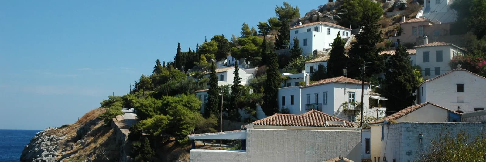 Coastal path and white houses on the hillside near Kamini, west of Hydra town