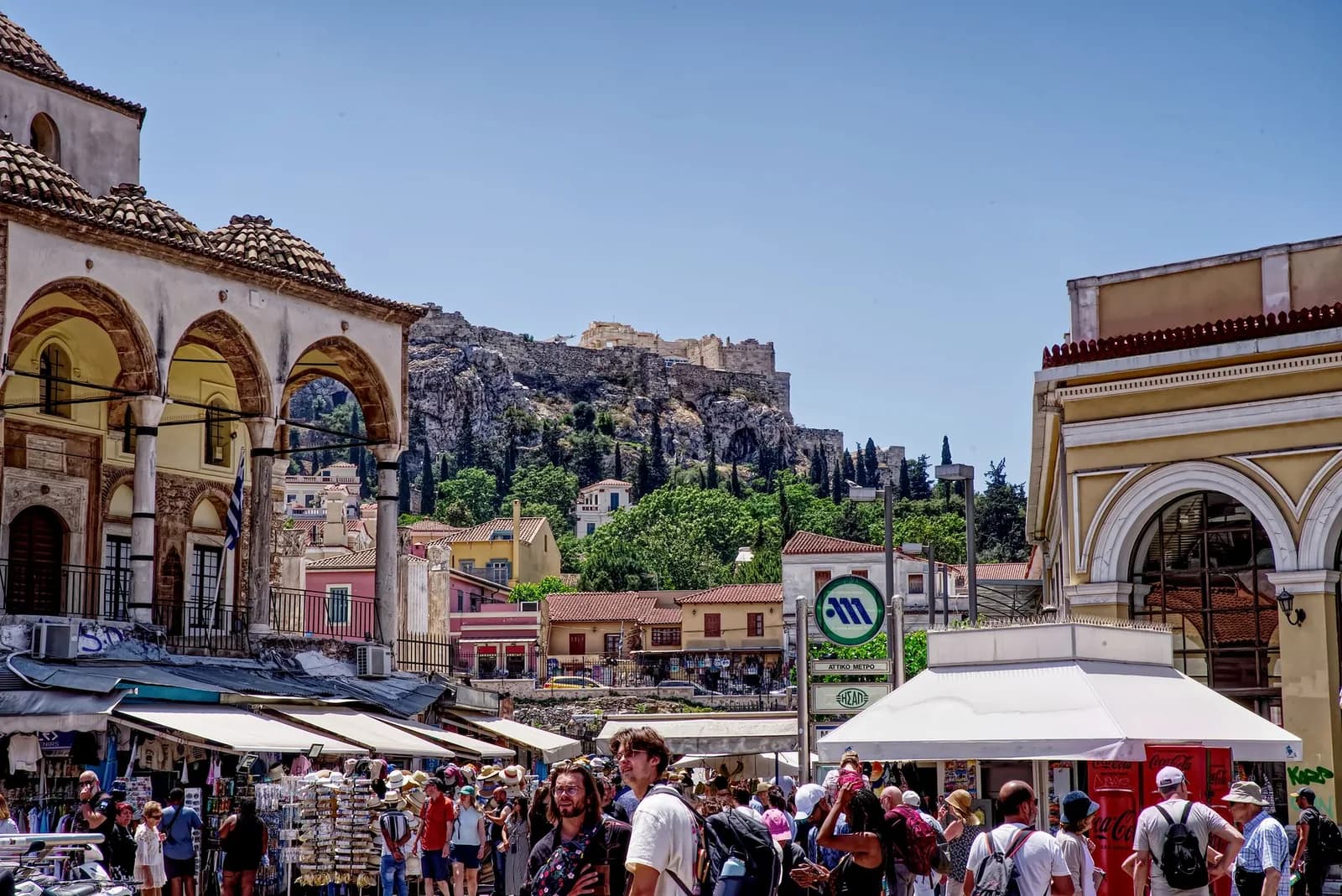 Monastiraki Square in Athens, with the Tzistarakis Mosque, the sign of Monastiraki metro station and the Acropolis rock behind