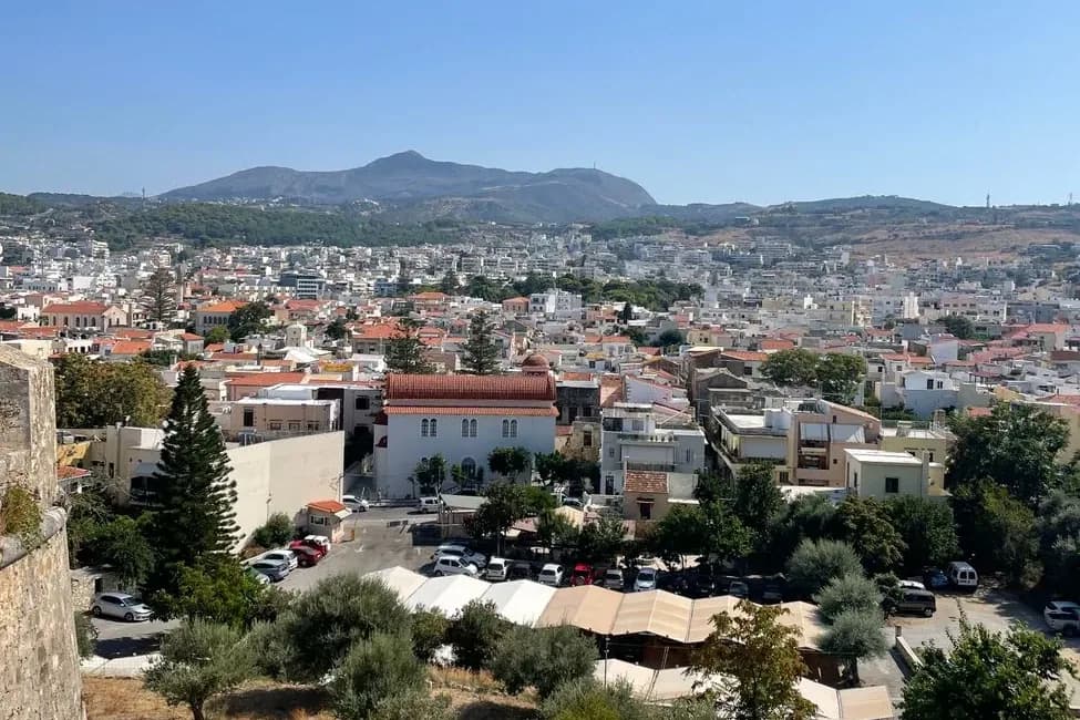 The tiled roofs of Rethymno old town and the modern town behind, seen from the Venetian Fortezza in Crete