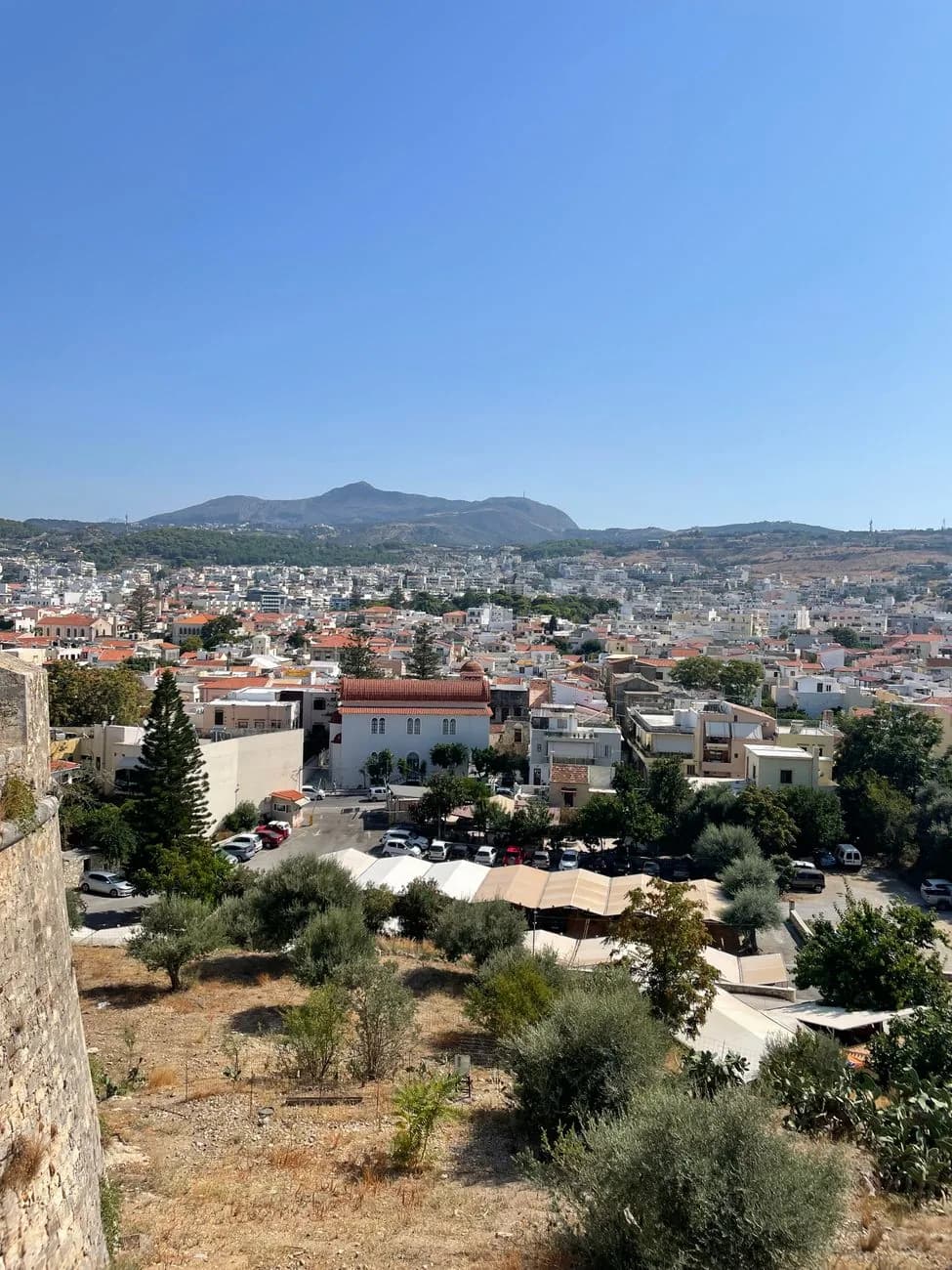 The tiled roofs of Rethymno old town and the modern town behind, seen from the Venetian Fortezza in Crete