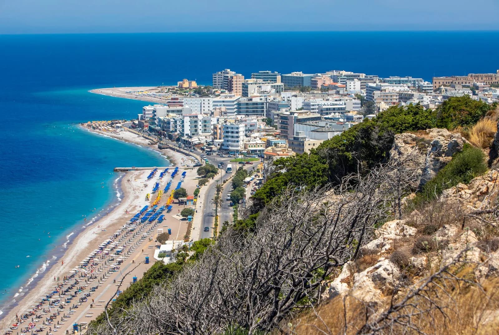 The hotel strip above the shingle beach on the west coast of Rhodes, looking north towards Rhodes Town