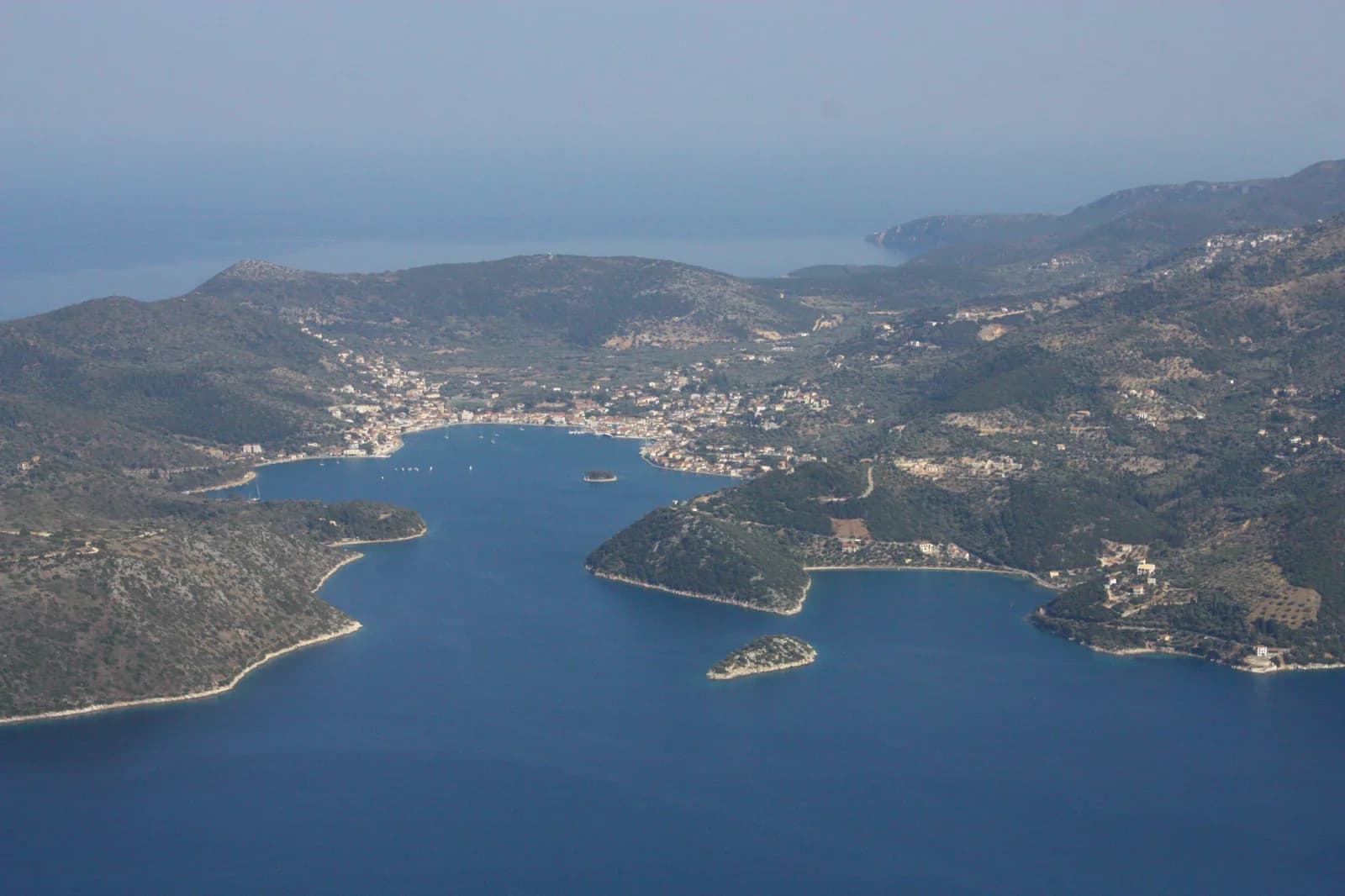 Aerial view of Vathy, the capital of Ithaca in Greece, at the end of its enclosed bay off the Gulf of Molos, with the hills of the southern half of the island around it